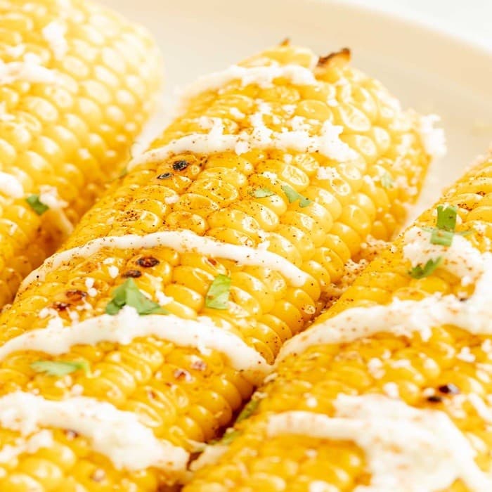Grilled corn with garlic mayo & grated cheese image